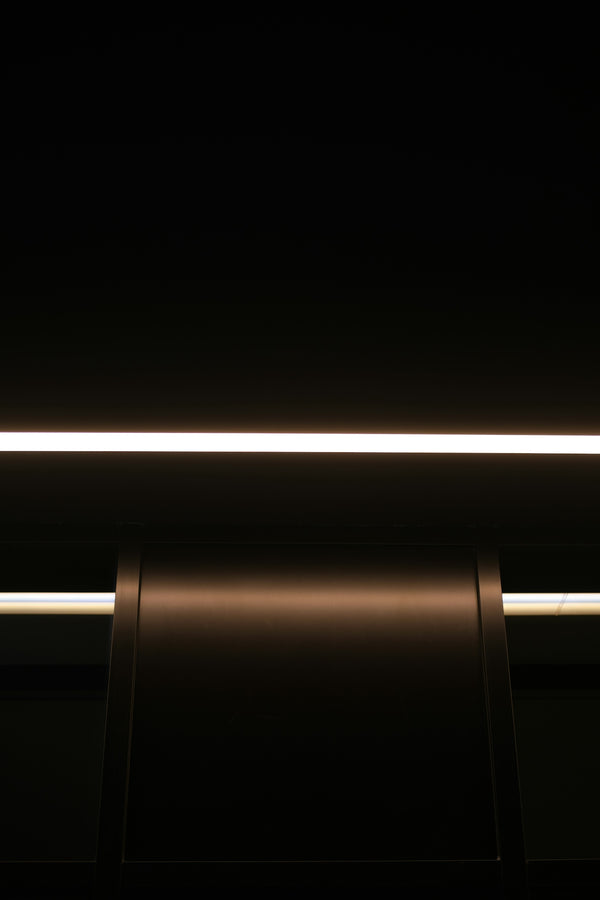 A dark, modern reception desk with overhead lighting