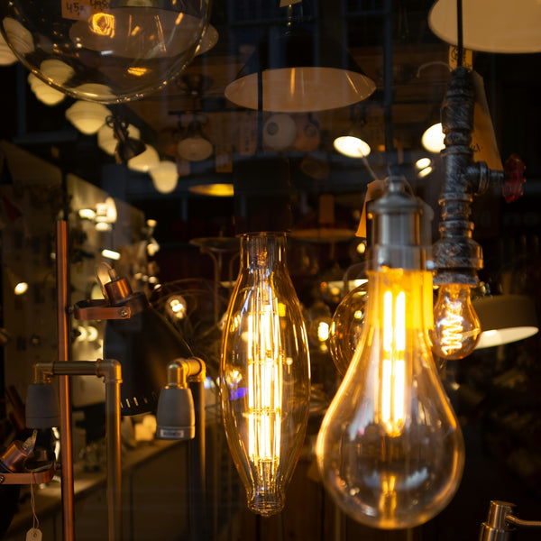 Various vintage edison light bulbs illuminated indoors